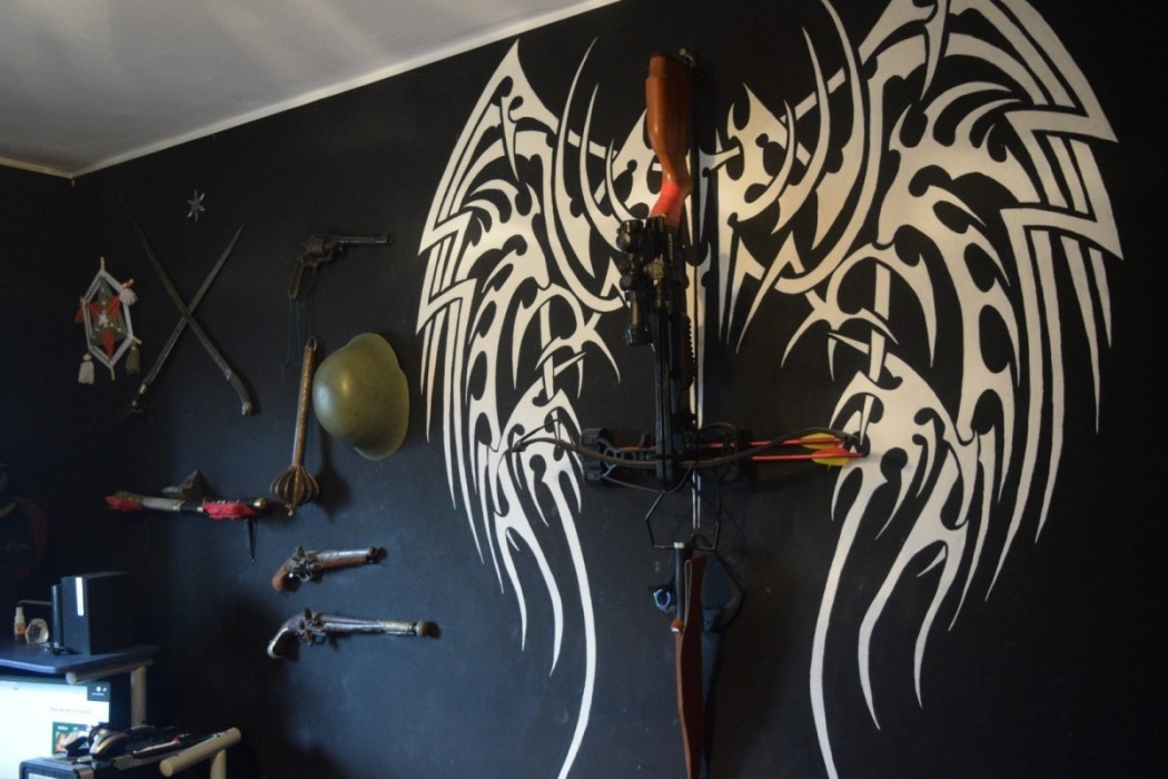 Crossbow on and wings on the wall